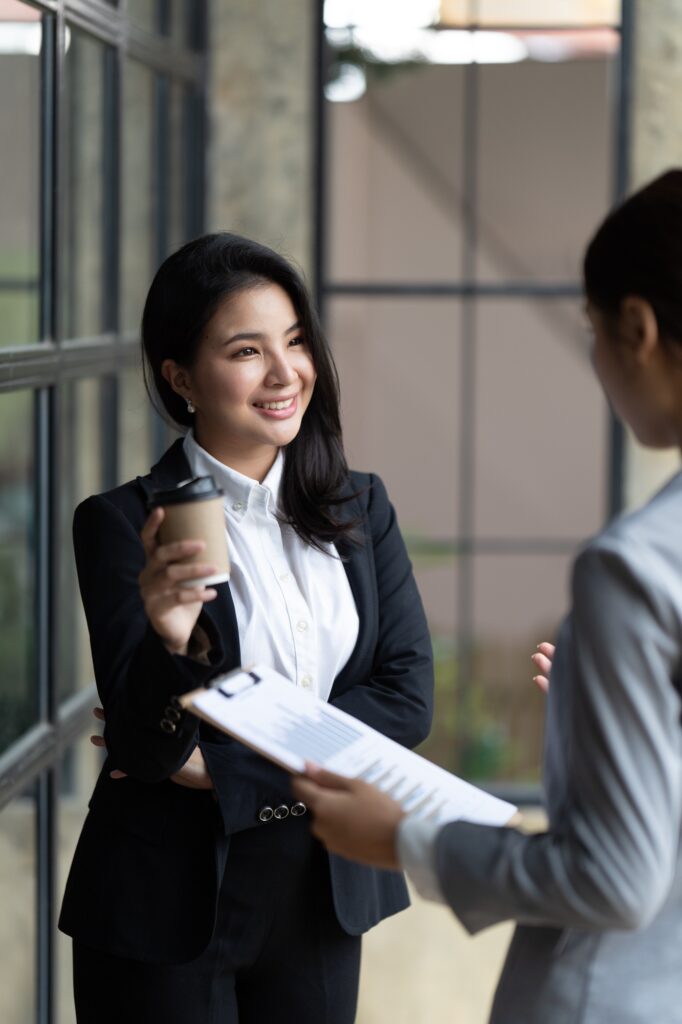 Confident focused businesswoman, teacher or mentor coach speaking to business people at negotiations